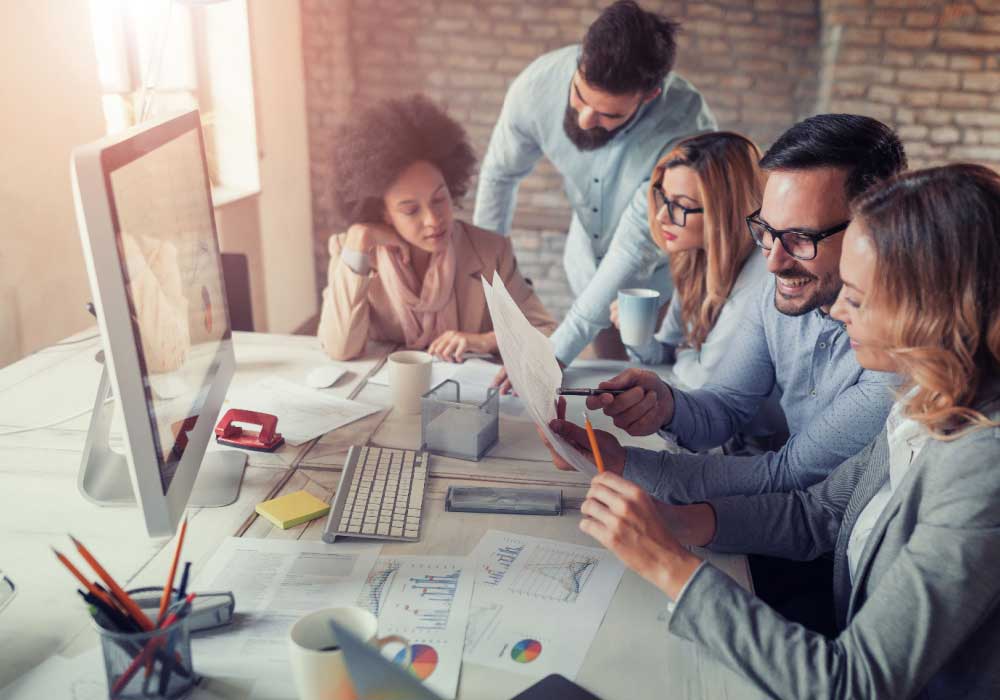 Marketing team collaborating on digital advertising strategy for small business