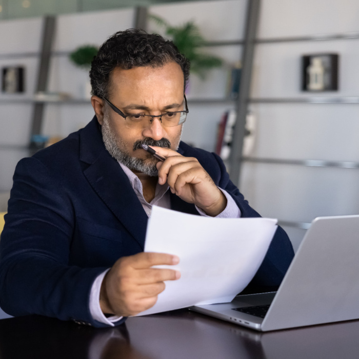 Law firm owner reviewing marketing performance and lead quality on laptop