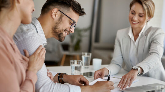 Real estate agent guiding clients through strategic home purchase decision